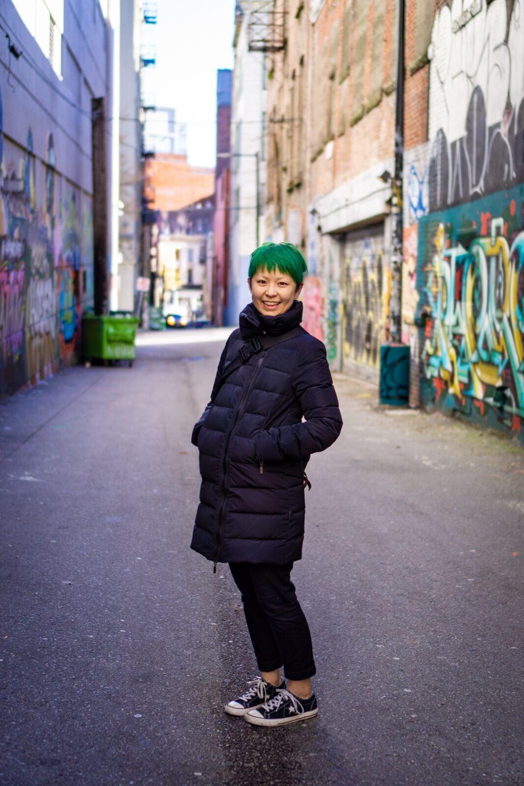 Portrait in a graffiti-lined city alley