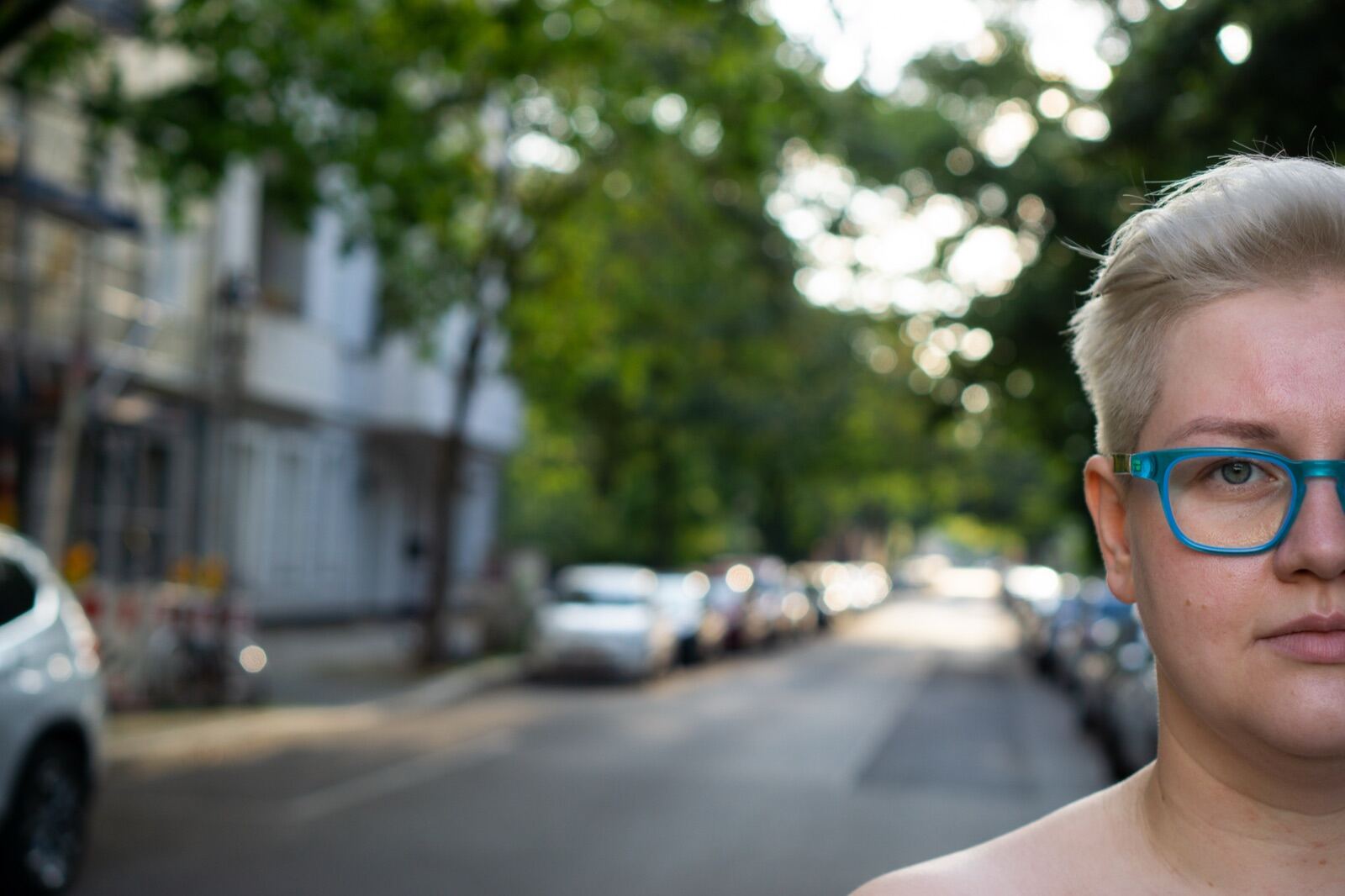 Street portrait with teal glasses