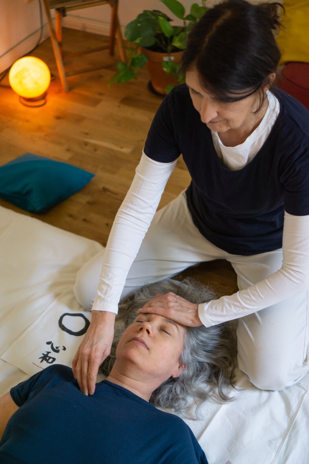 Gentle bodywork session in a warm studio