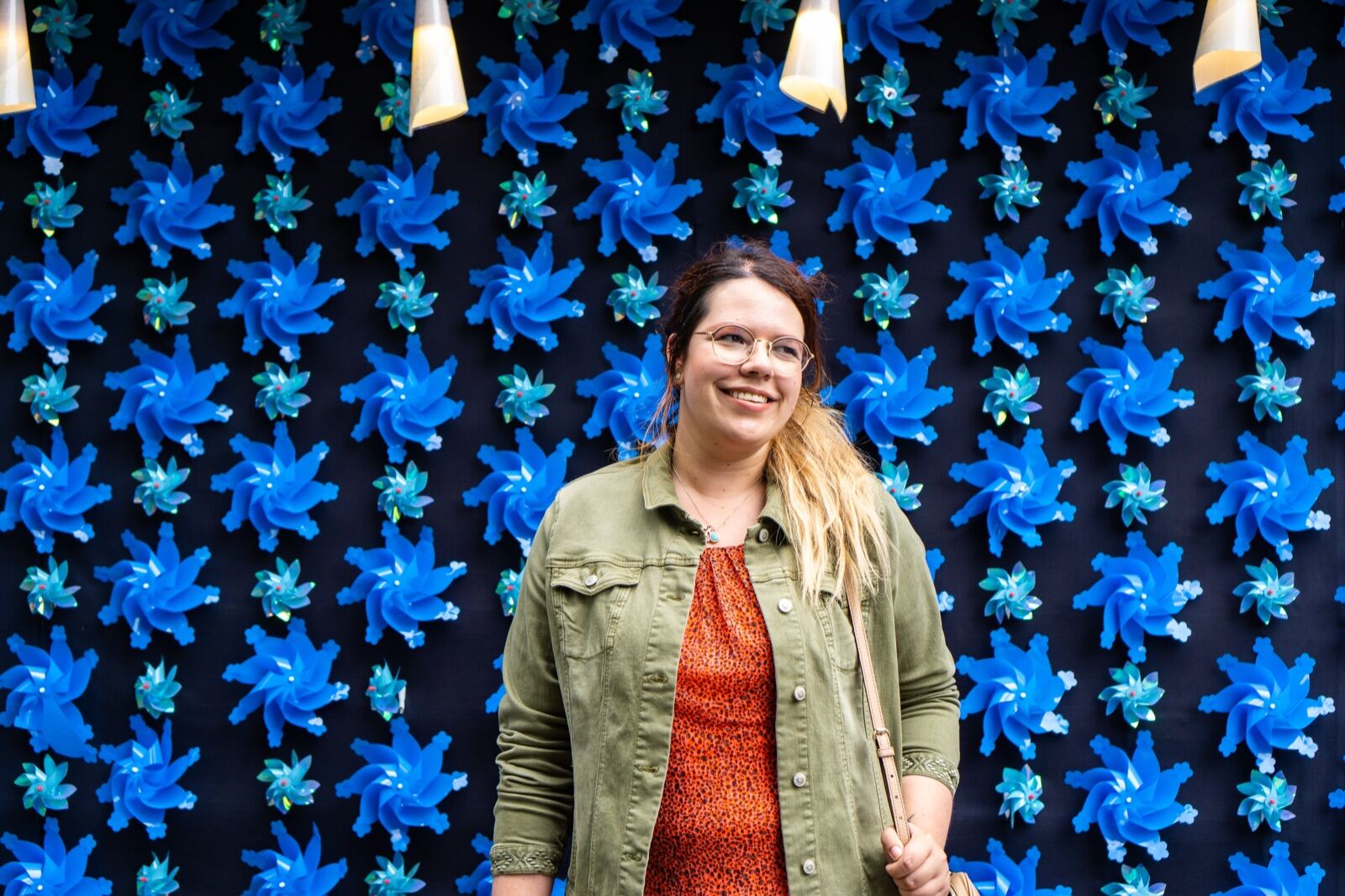Portrait against a wall of blue pinwheels