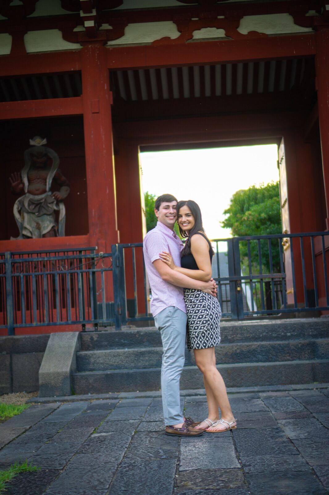 Couple embracing at a temple gate